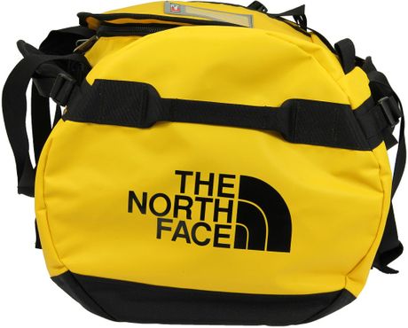 yellow duffel camp base bag face north