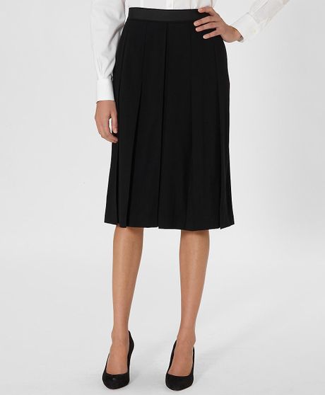 Black wool pleated skirt Wool Midi A-Line Skirt: Wool skirt with a slight A-line silhouette and a modern front inverted pleat that adds a unique touch. Front and back darts create a great shape. Front .
