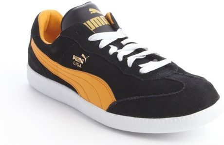 puma black and orange sneakers
