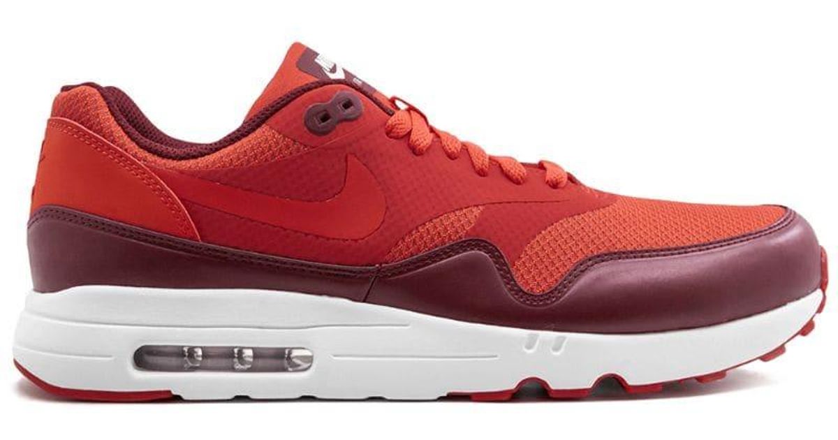 tan and red nikes