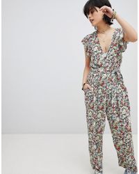 Free People Ruffle Your Feather - Bedruckter Jumpsuit mit Gürtel - Mehrfarbig