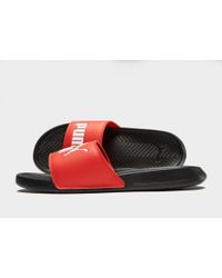 red and black puma slides