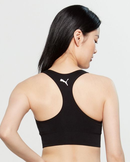 Download PUMA Re-invent Seamless Sports Bra in Black - Lyst