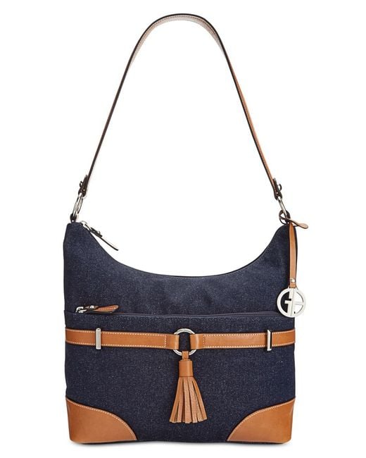 Hello, hobo. A pop of colorful leather highlights the shoulder-right shape of this Dooney & Bourke favorite featuring a divided interior and signature monogram.
