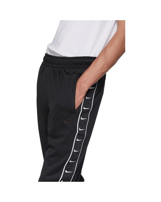 nike taped poly track pants black