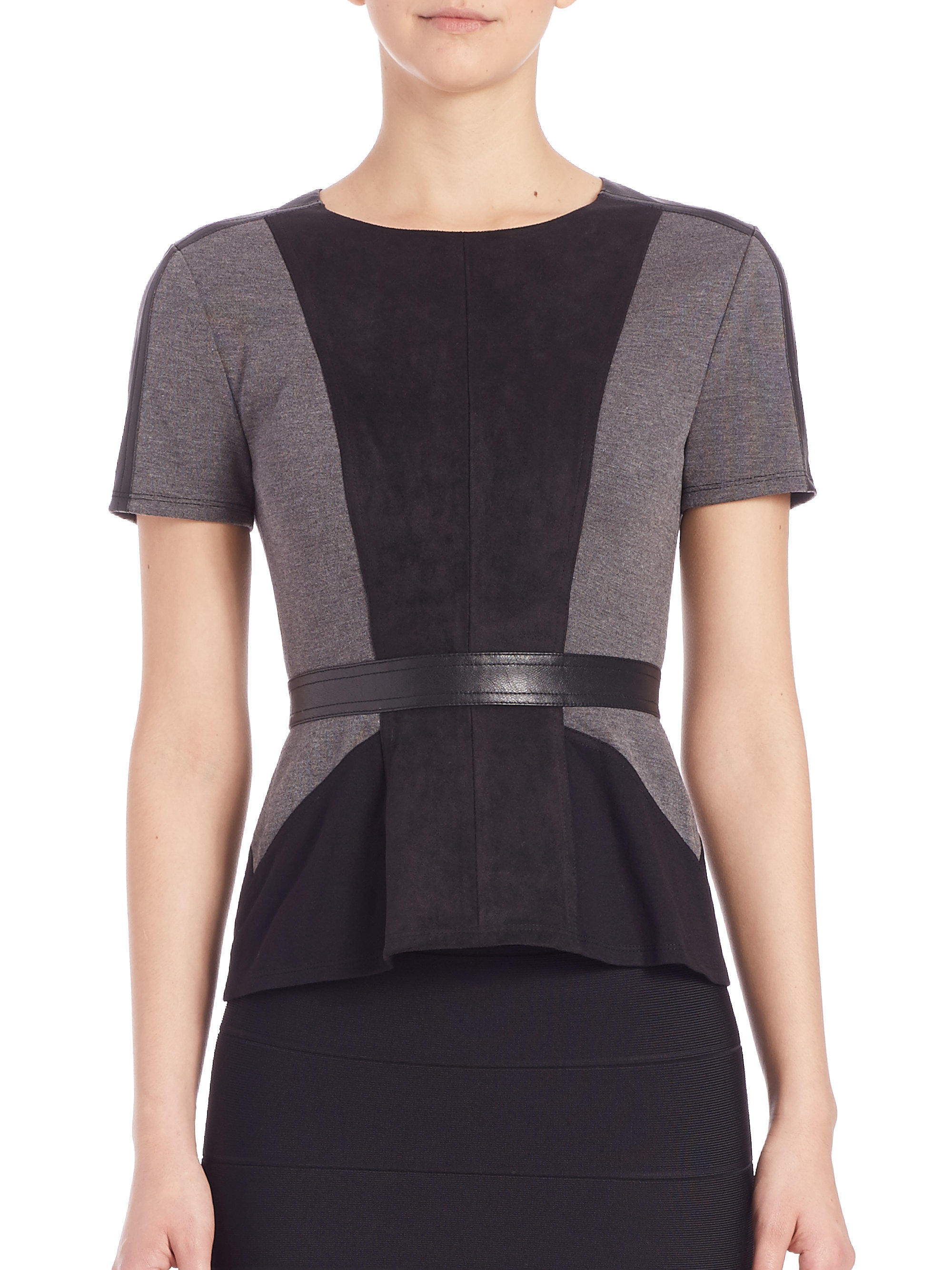 You might enjoy... The soft, light grey is a shade that is easy to mix and match with all her accessories. The scoop neckline is framed with short sleeves. The casual fit falls to the hem that is dressed in a ruffle.