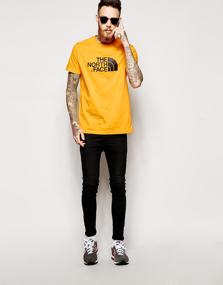 black and yellow north face t shirt