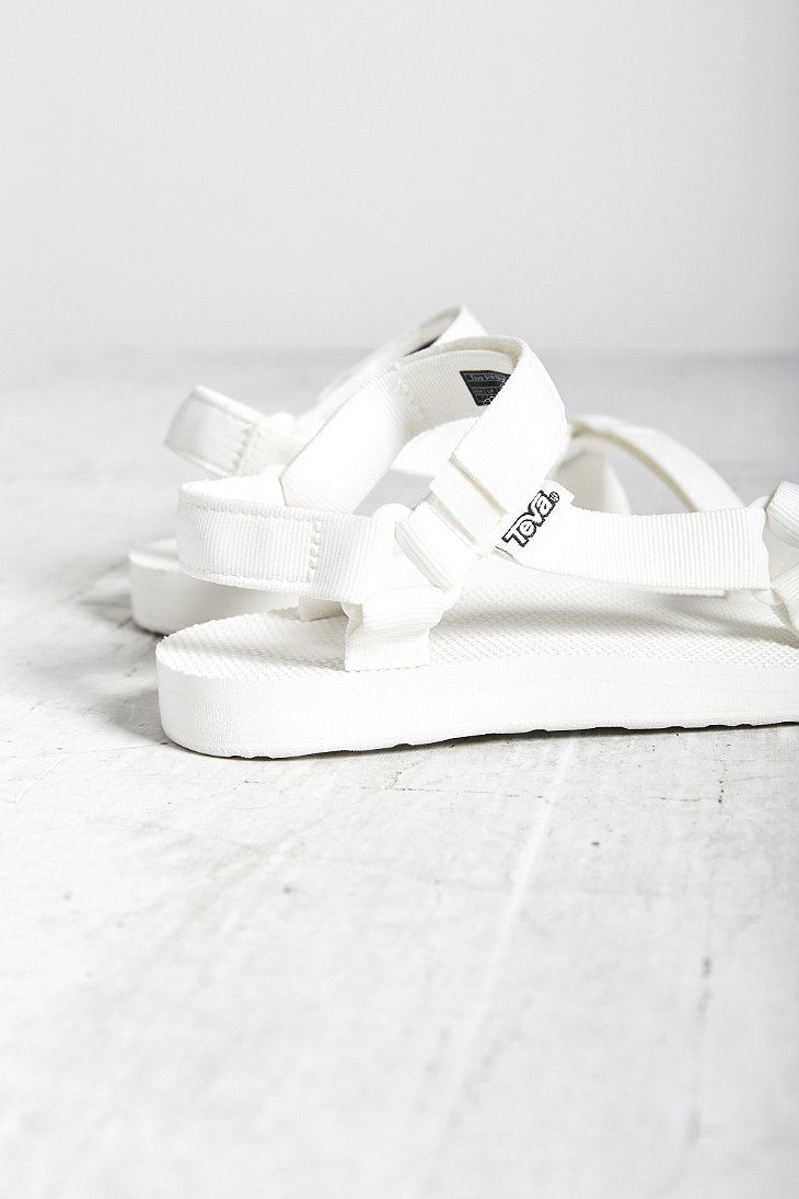 white teva flatforms