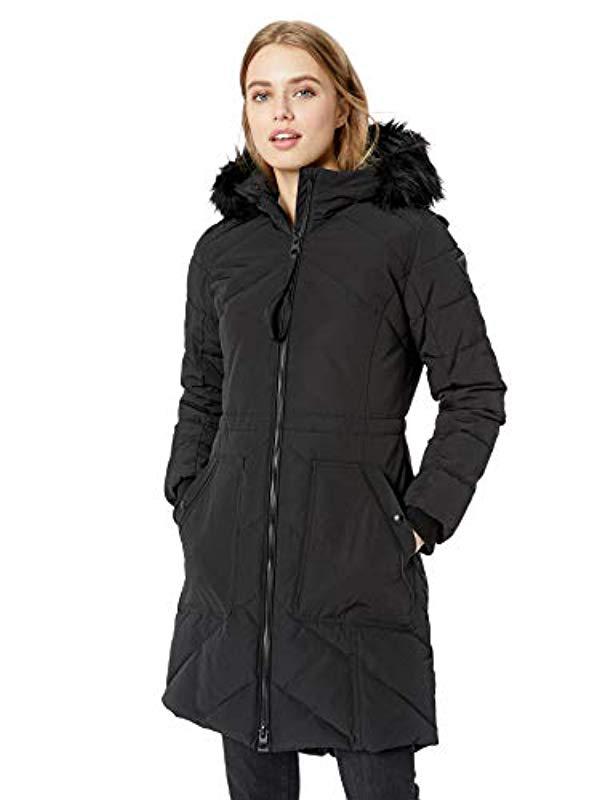 Lyst - Guess Knee Length Heavy Puffer Coat With Faux Fur Trimmed Hood ...