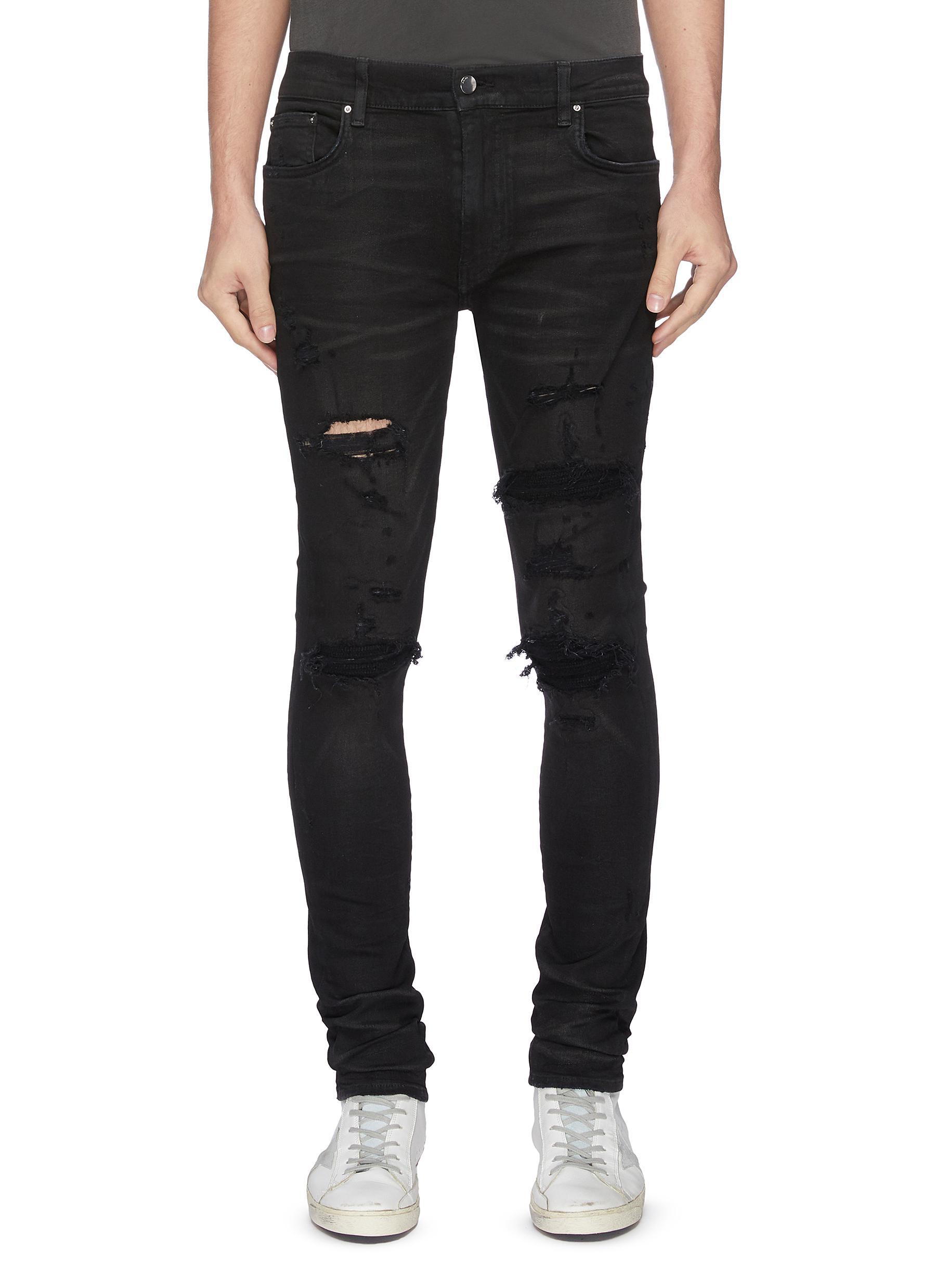 Amiri Distressed Cashmere Patch Jeans in Black for Men - Lyst