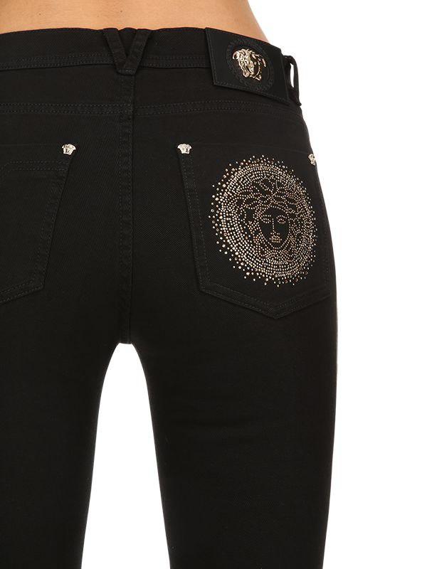 Lyst - Versace Medusa Embellished Slim Denim Jeans in Black