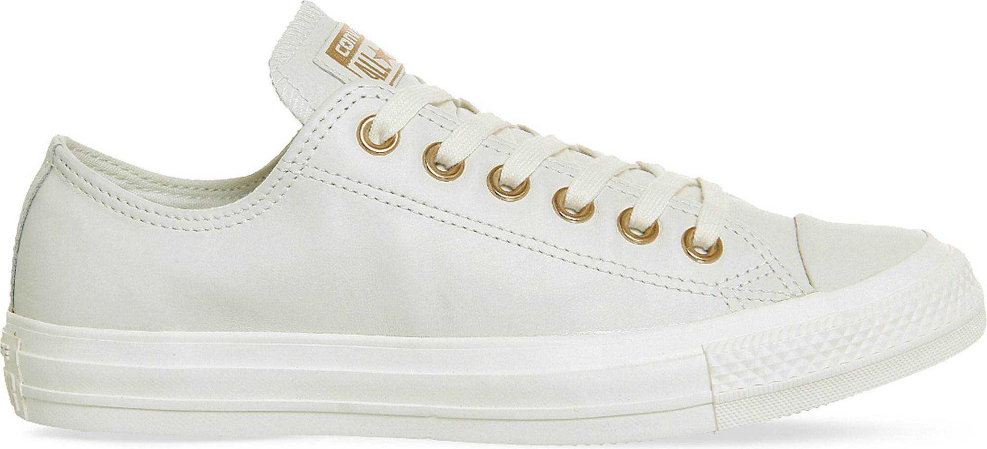 white and gold leather converse